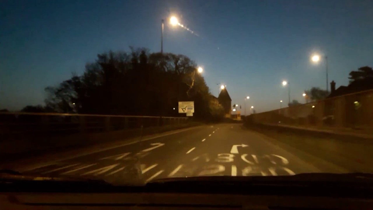 drive in the dark as the sun begins rising in the early morning dawn