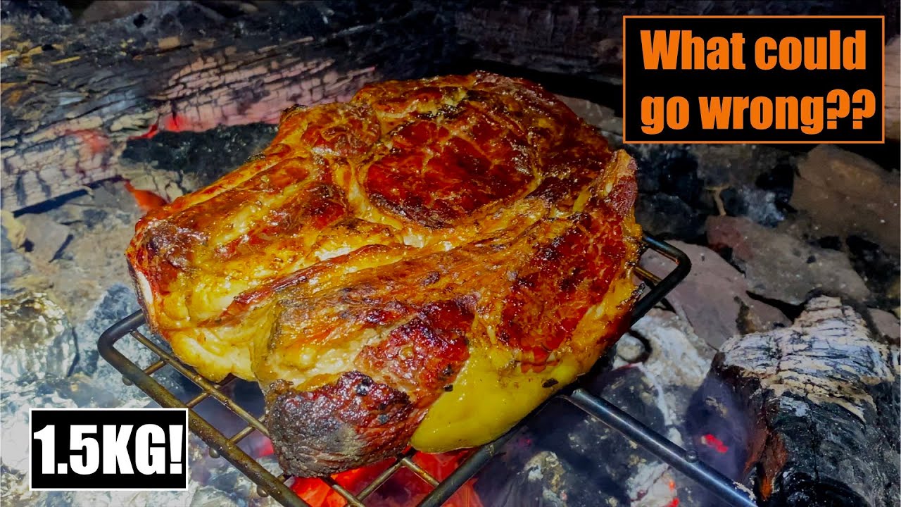 Huge steak cooked over a campfire with beers!