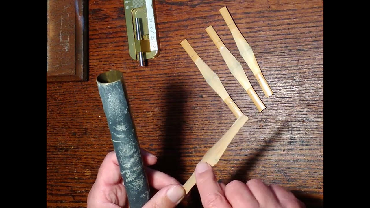 Scoring and beveling bassoon cane in preparation to form a reed blank.