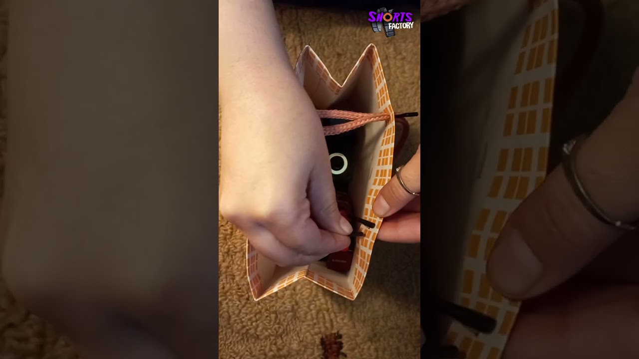 Closing a gift bag with its own string 