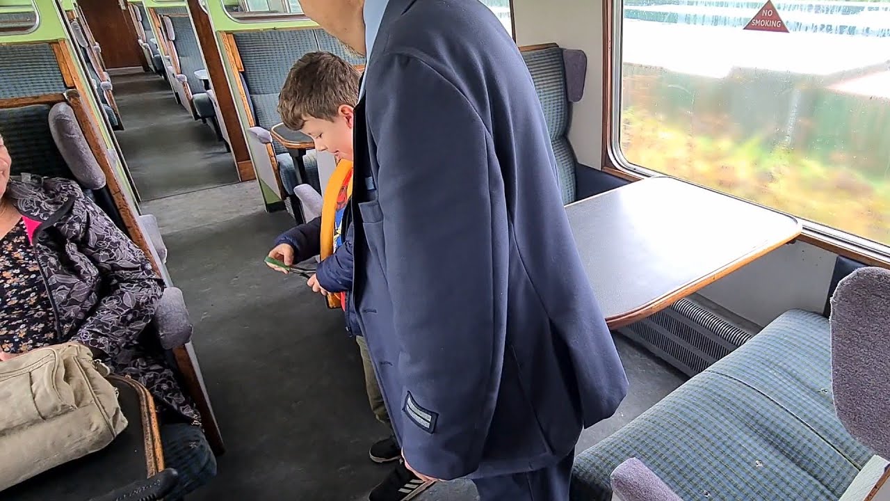 Oswestry Hertiage Railway. Clive teaching Daniel to clip the passengers tickets.