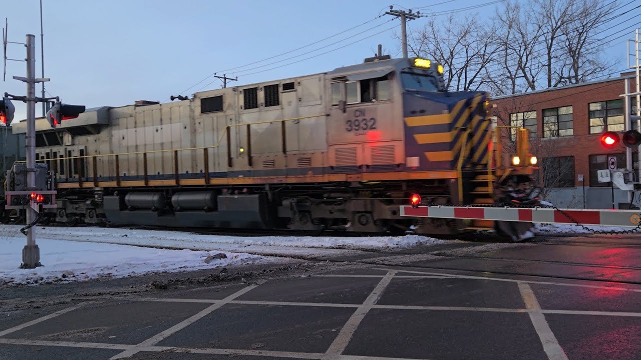 WINTER TRAINS Single CN Silver Ex Citirail ES44AC and 52 Hoppers at St Ambroise Street Crossing 