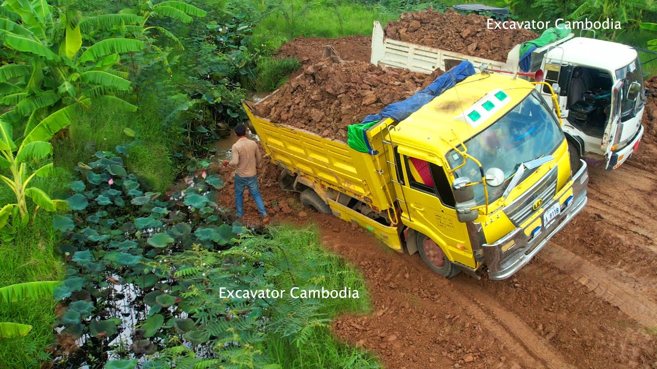 The Truck Driving Backwards Unloading Landslide Stuck Recovery By Technical Operator Mini Dozer