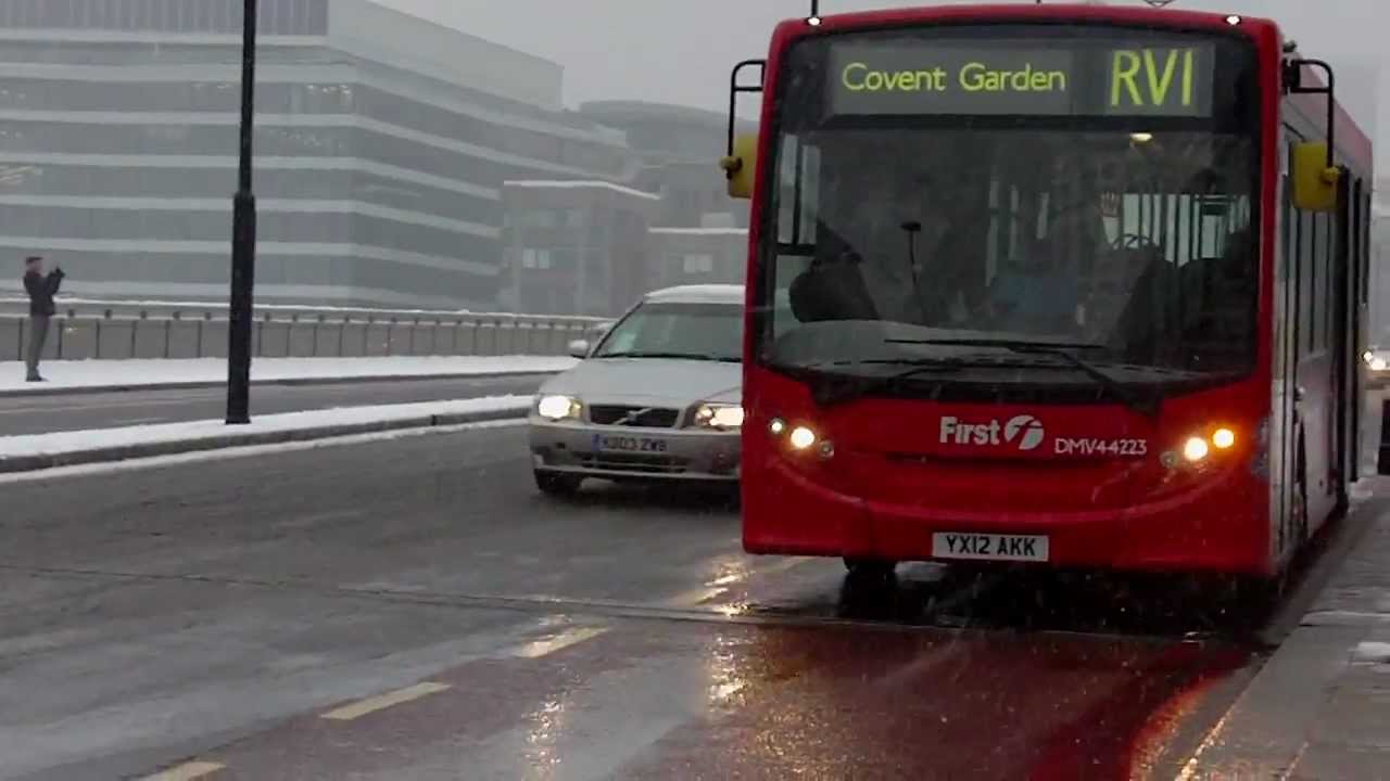 Buses at London Bridge during snow