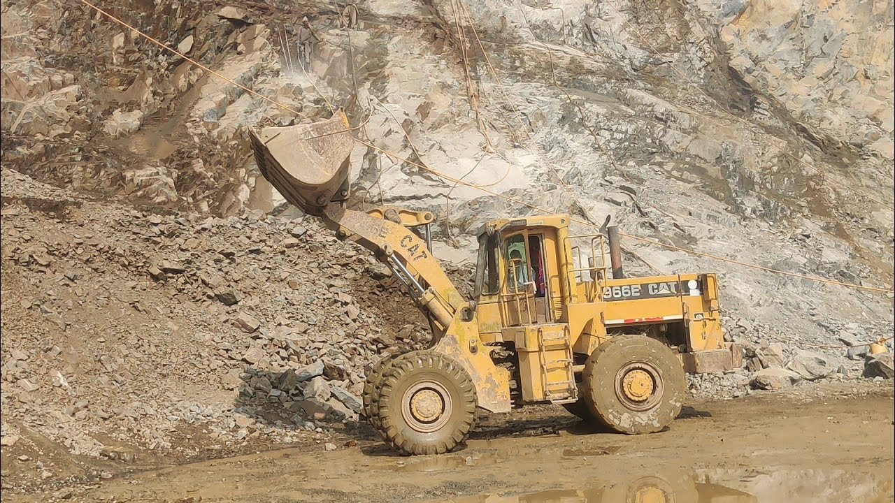 Four Wheelers Caterpillar Loadar load Stone With him Power Showing in Mountain