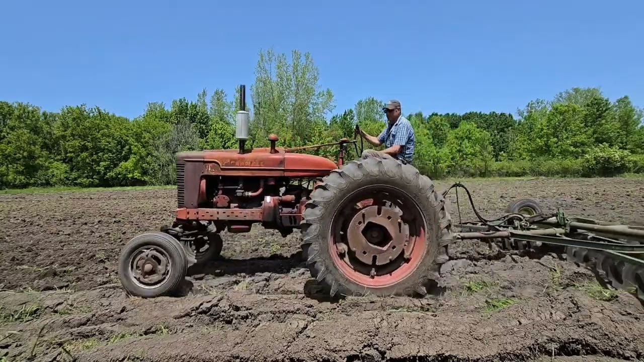 Farmall m discing the field