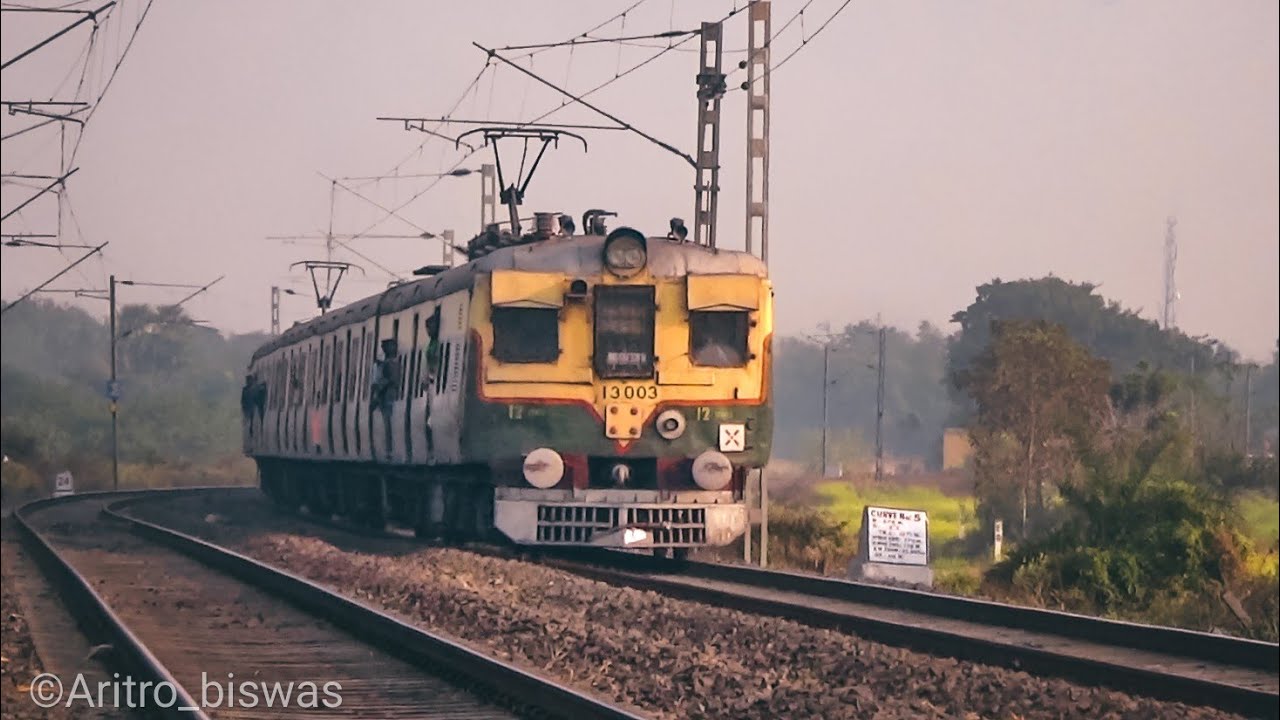 Vintage green colored EMU local trains on a curvy rail track