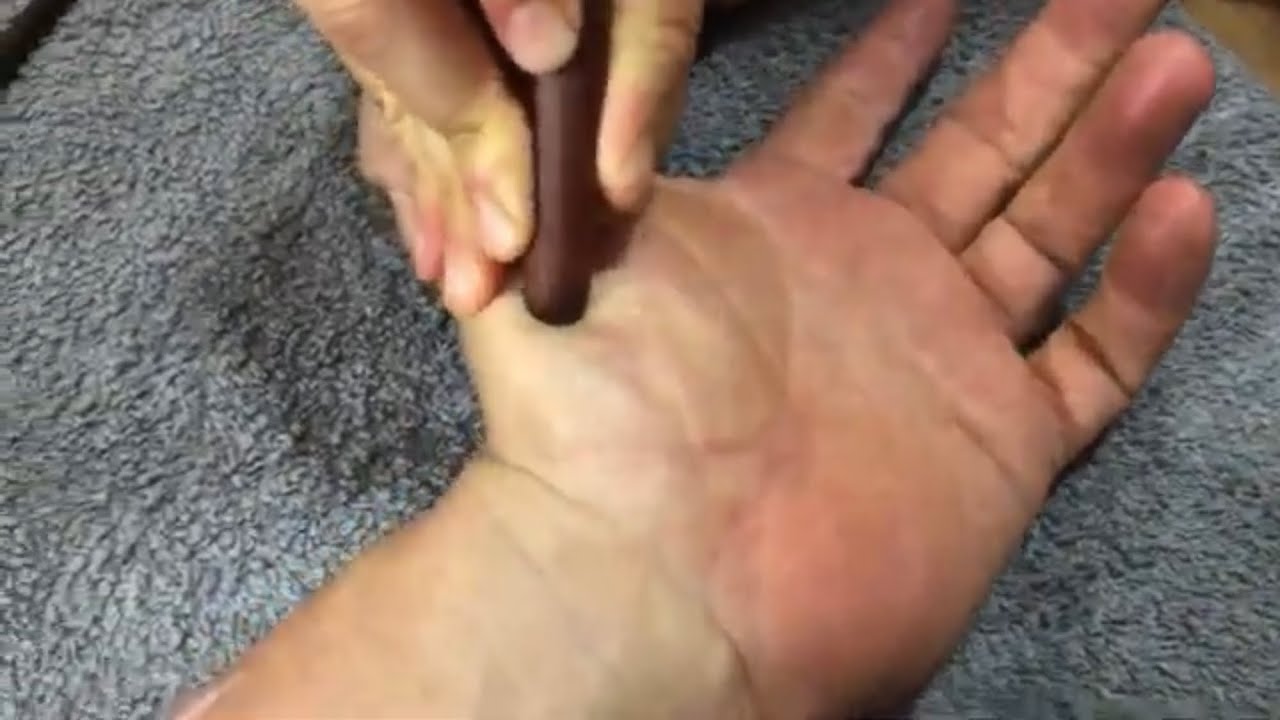 Hand massage and reflexology using massage tools. Part 2 of Brandon having his hand massaged