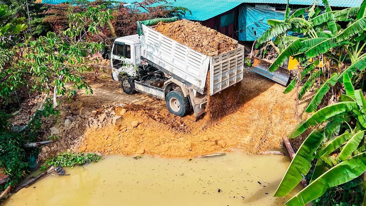 Best Dozer KOMATSU D31P Pushing Soilrock Filling Up Delete Pond with 5Ton Dump trucks Dumping soil