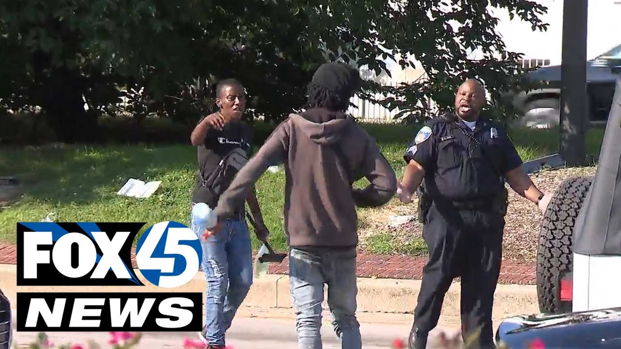 Squeegee kid and police officer in verbal confrontation Downtown Baltimore
