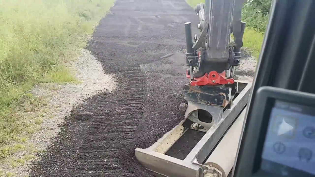 Levelling road planings on a farm track