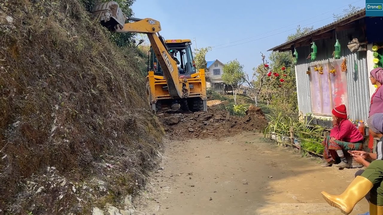 Cutting Hillside by Mountain Village House with JCB 3DX Backhoe for Mountain Road