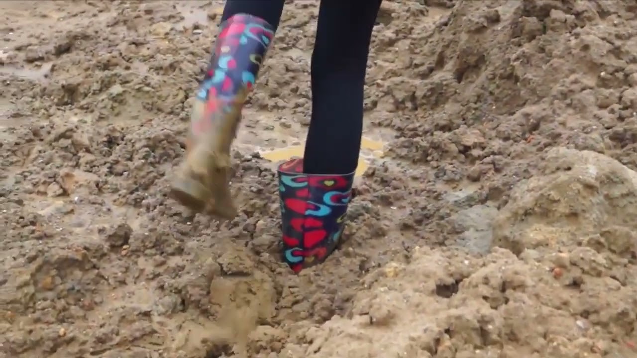 Girl in rubber boots stuck in mud