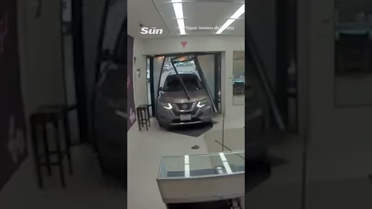 Moment masked jewelry thieves crash car into store door