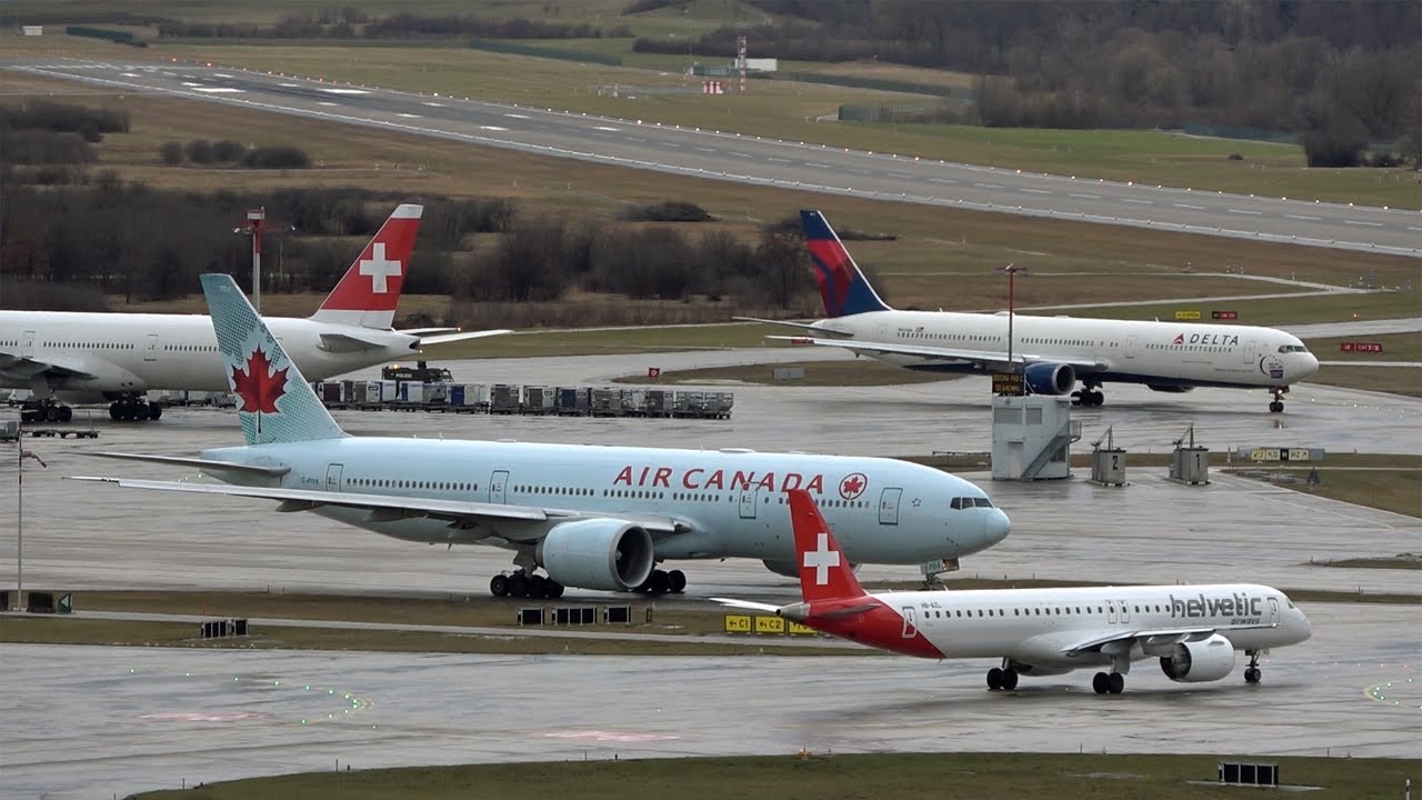 Airplanes at strong westwind and rain at Zurich airport ZRH