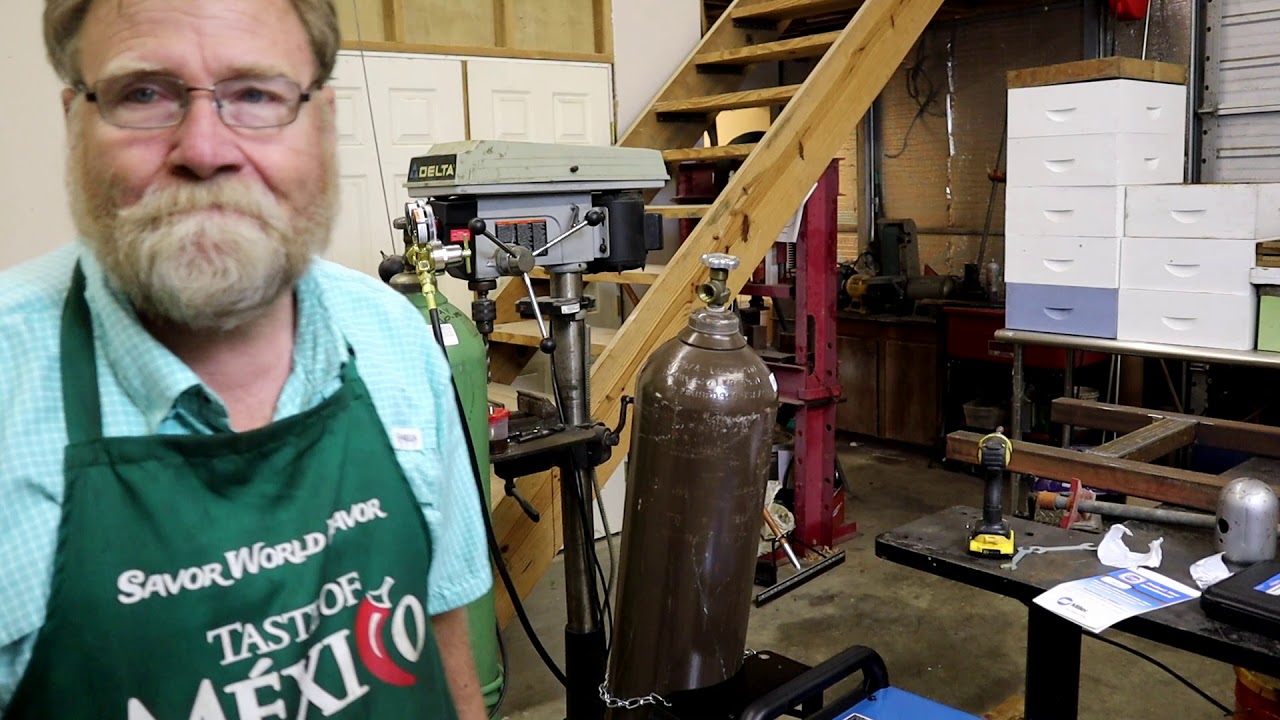 255 Miller welding the ant traps on the Bee Stands