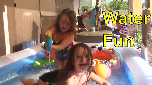 Playtime in the Pool Family Fun Water Gun Fight Kids playing in the water
