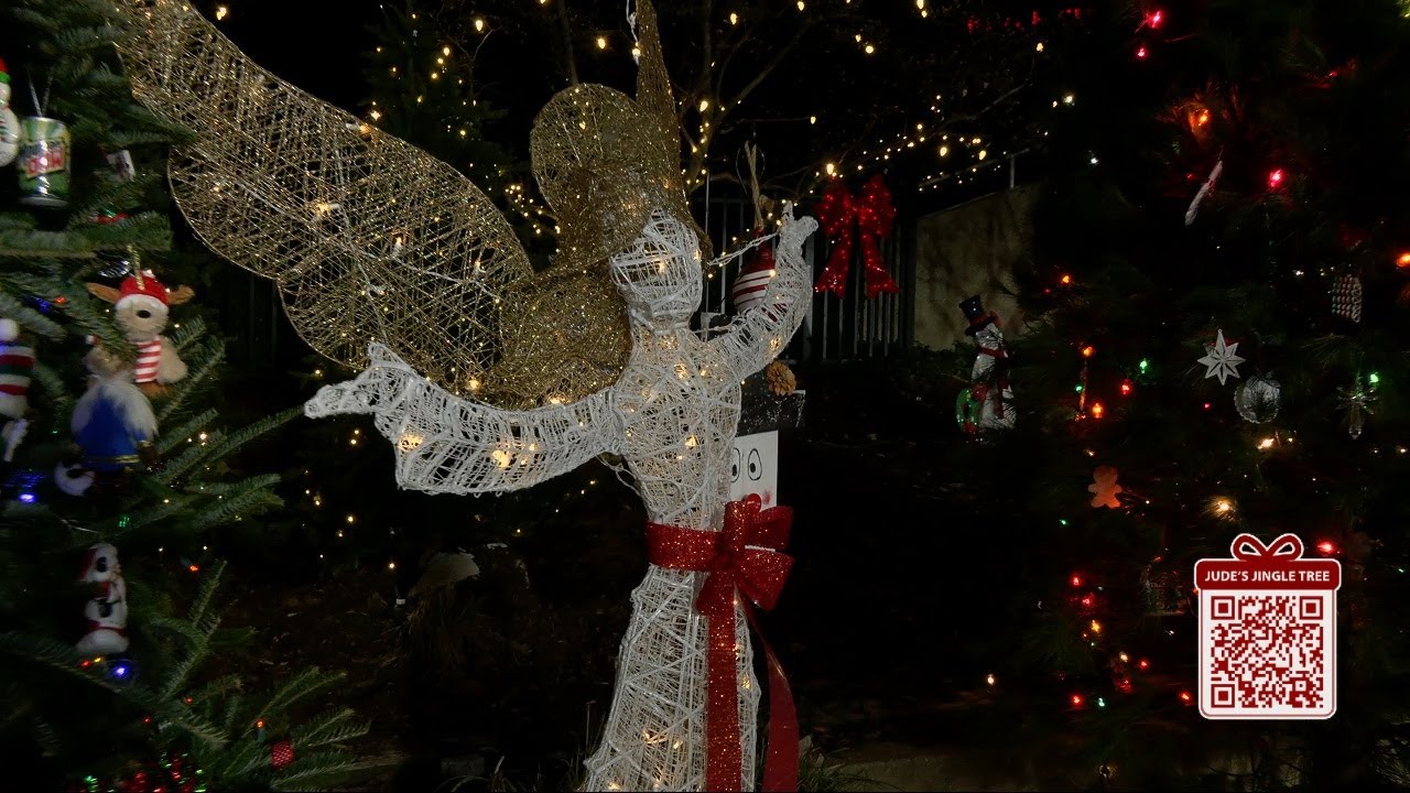 Jude Redfield shows off viewers' ornaments adorning the Jingle Tree