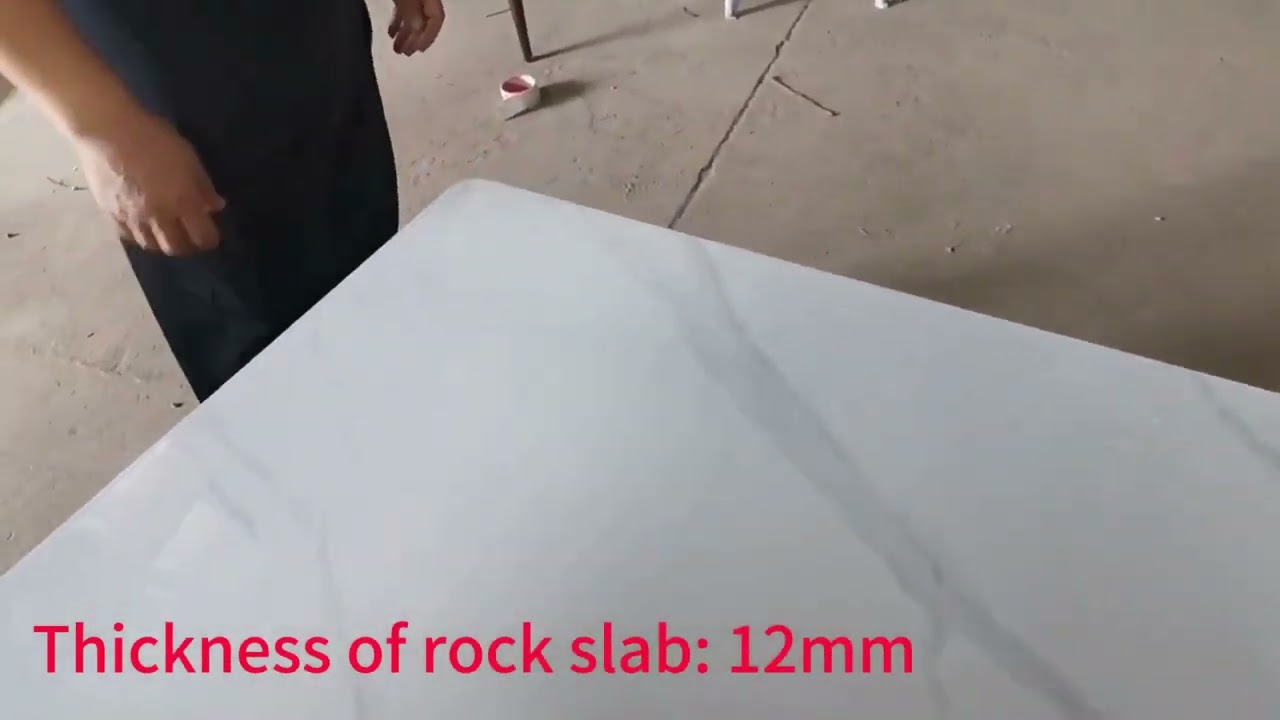 This dining table is made of slate，carbon steel and marble slab.