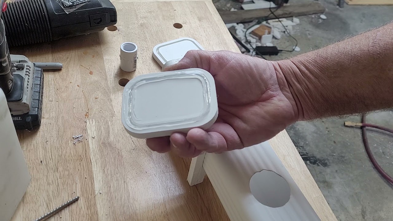 Installing gutter downspout endcaps.