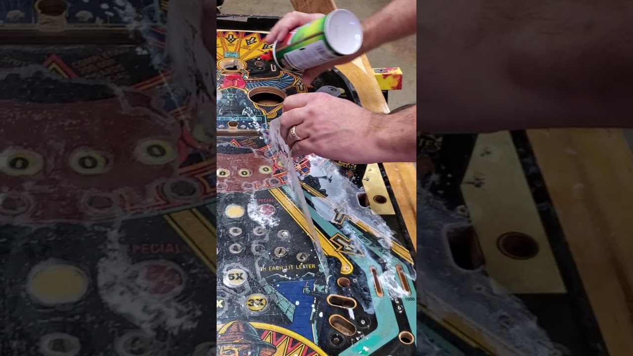 Remove mylar from pinball playfield.