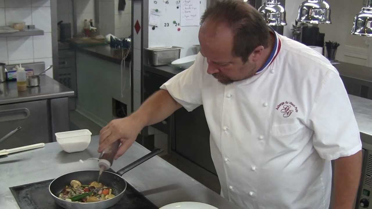 Gilles Goujon prepares a dish at his Auberge du Vieux Puits