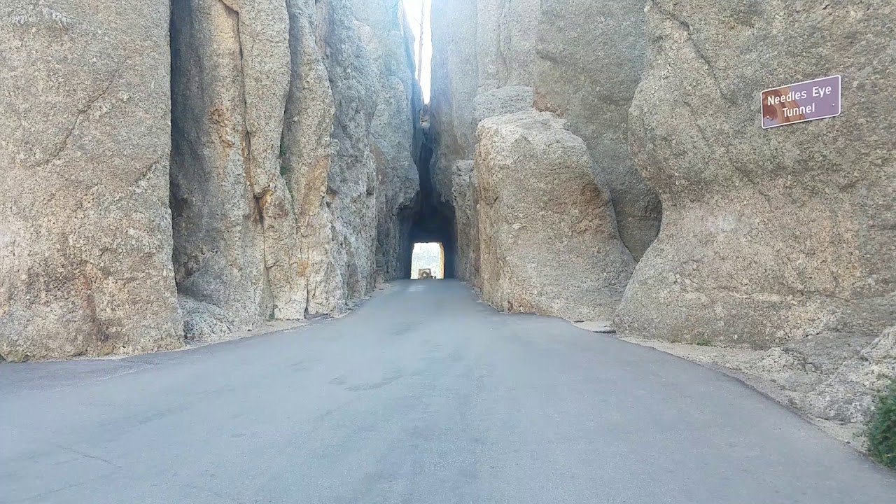 Driving Jeep Wrangler through the Needles Eye Tunnel in Custer State Park South Dakota