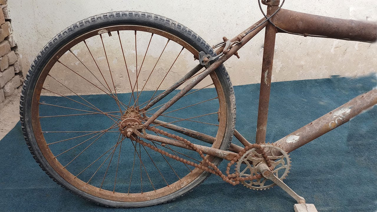 RESTORATION - A Villager Restoring Old Bicycle Wheel For Same other Bicycle