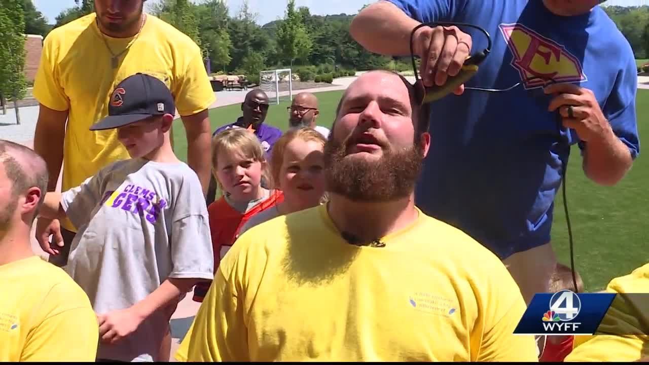 Clemson football players get their heads shaved for a good cause