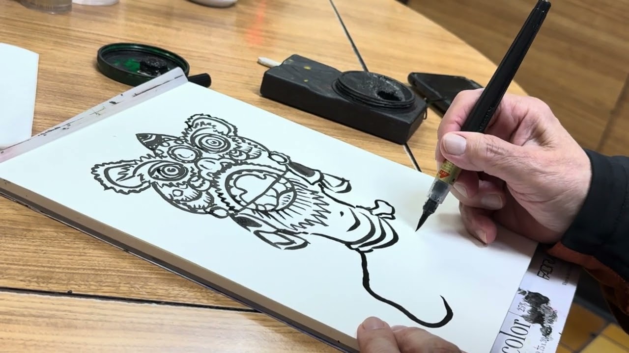 Leland Wong drawing artwork for Chinatown Lion Dance Festival 2024