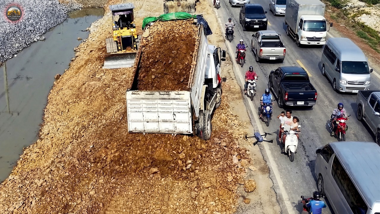 Komatsu D31P Dozer & Dump Trucks Working on Long Drain Landfill Project.