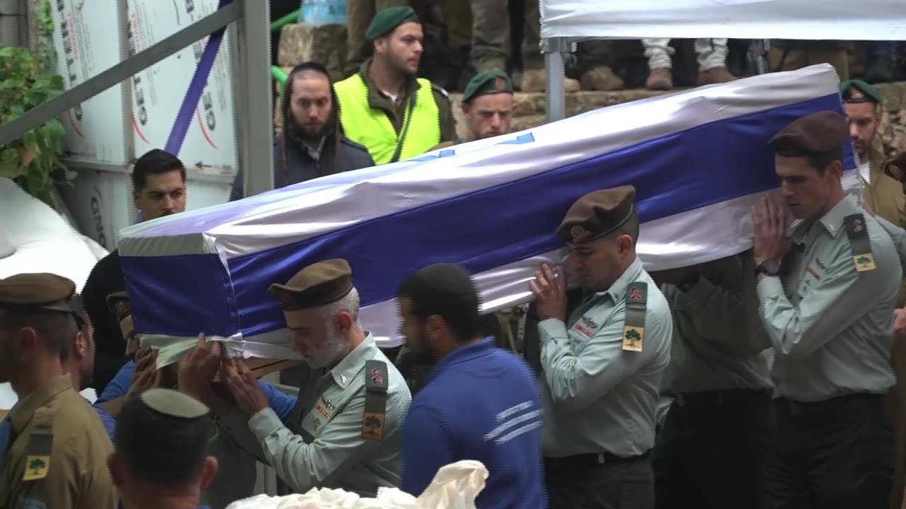 Hundreds of Israelis gather in rain in Jerusalem to mourn death an officer killed in Gaza