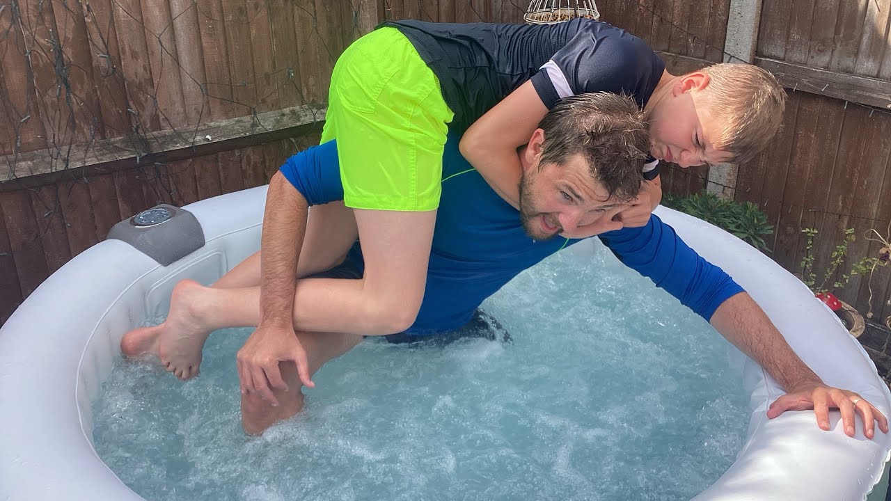 Dad vs son swimming pool wrestling match