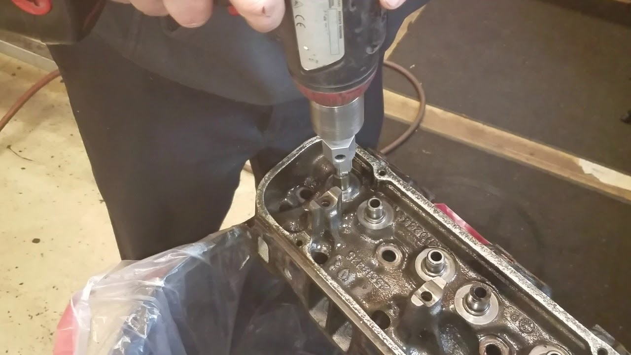 Cutting down valve guides on stock heads for positive seals and smooth stem valves.