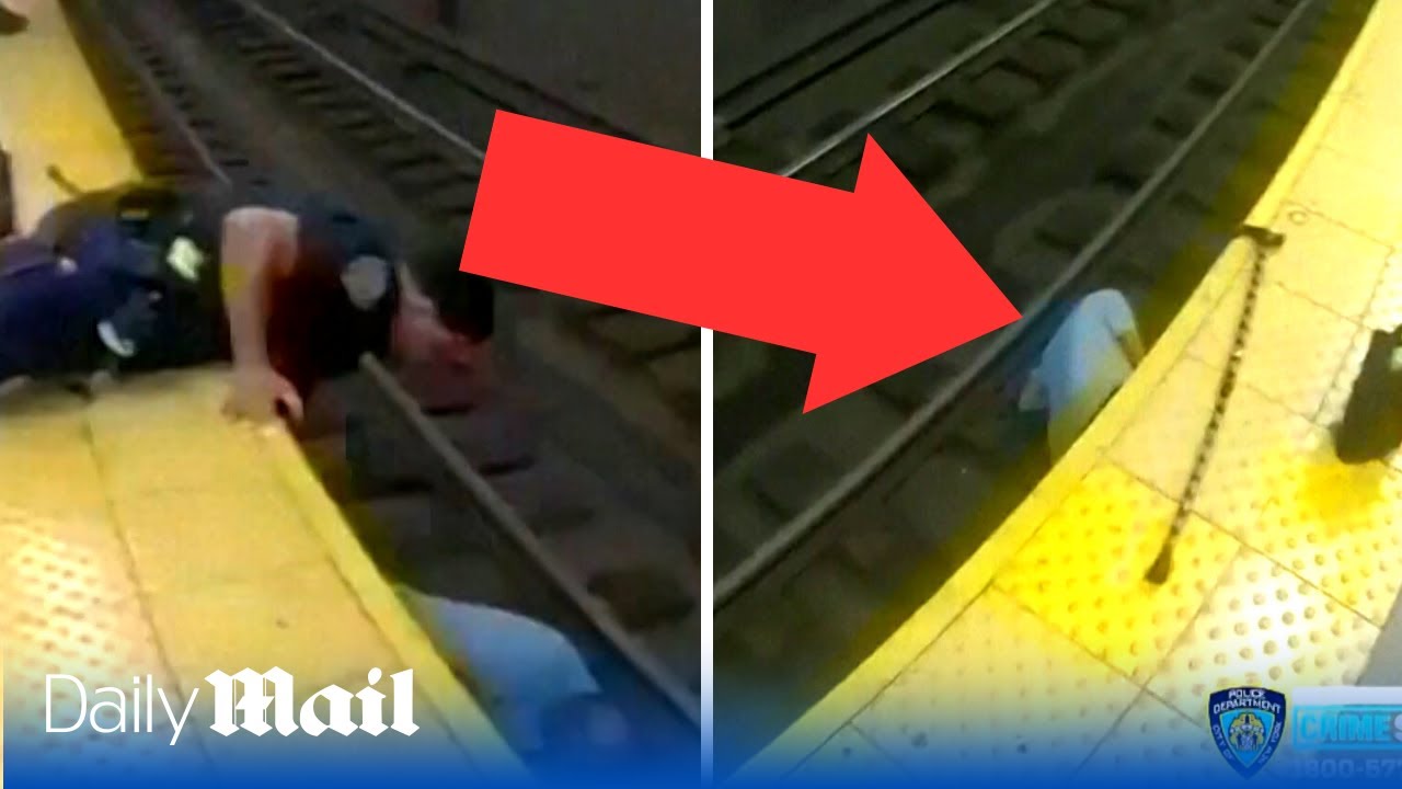 Dramatic moment heroic police officers rescue man collapsed on subway tracks