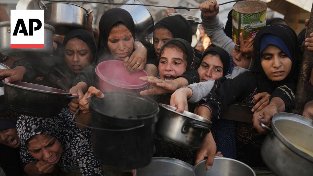 Desperate Palestinians crowd a charity kitchen in Gaza
