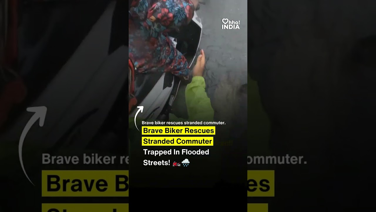 Brave biker rescues stranded commuter trapped in flooded streets! 🏍️🌧️ #shorts #youtubeshorts