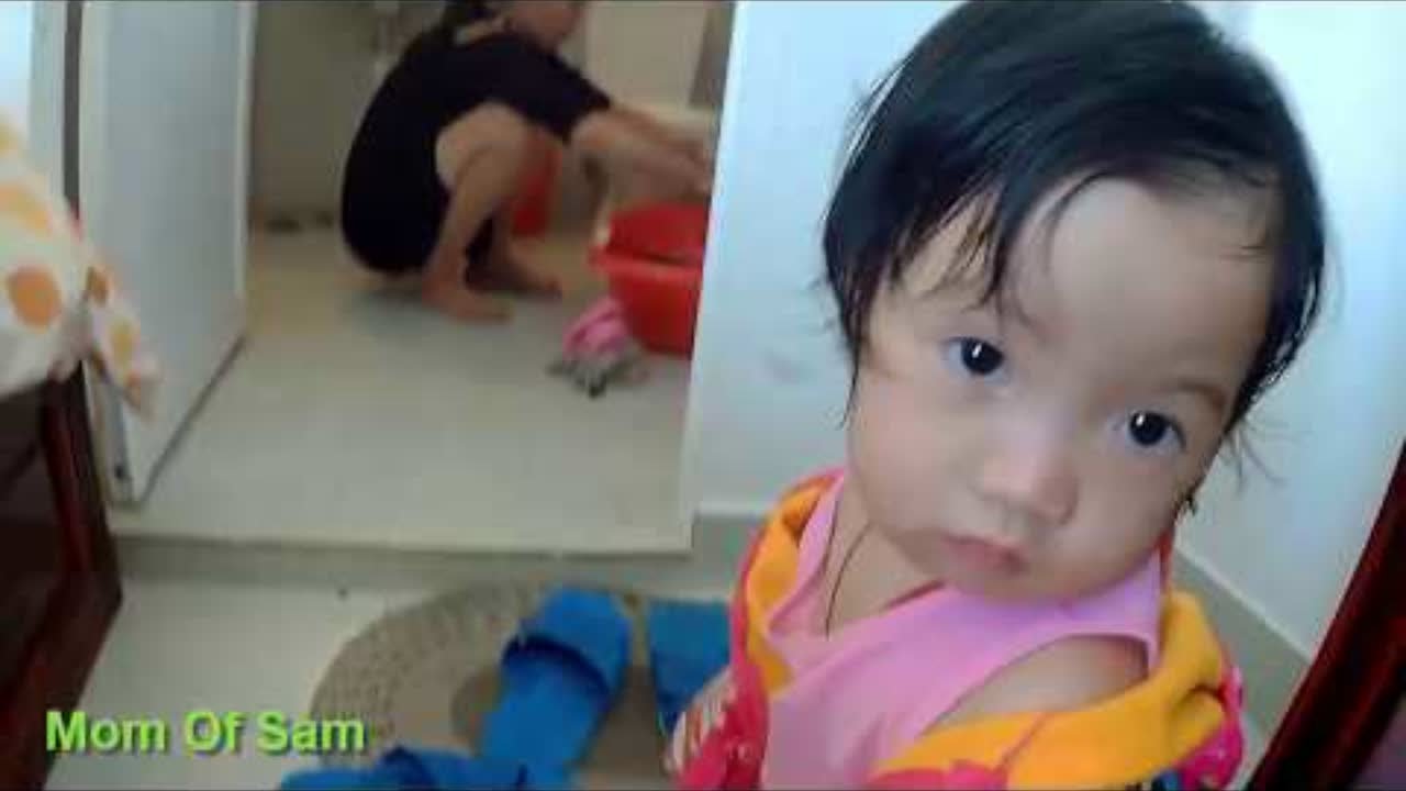Beautiful Single mother cleaning the bathroom