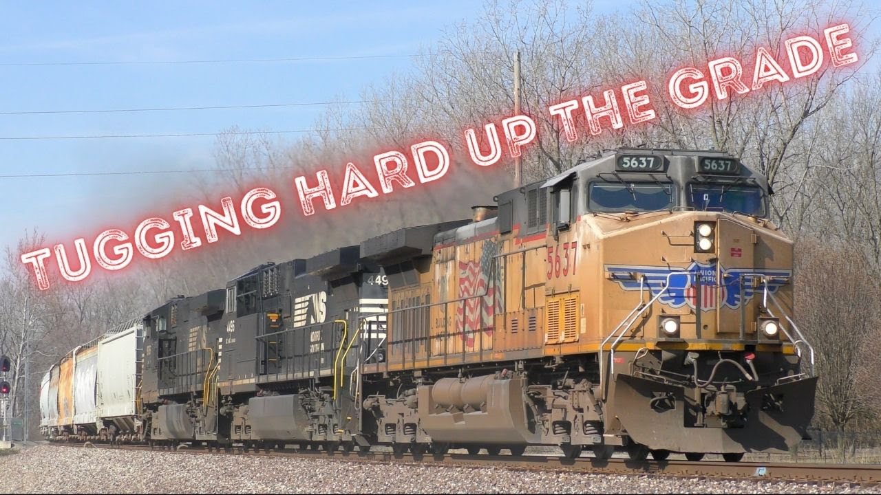 Long, Heavy freight trains tugging hard up the grade