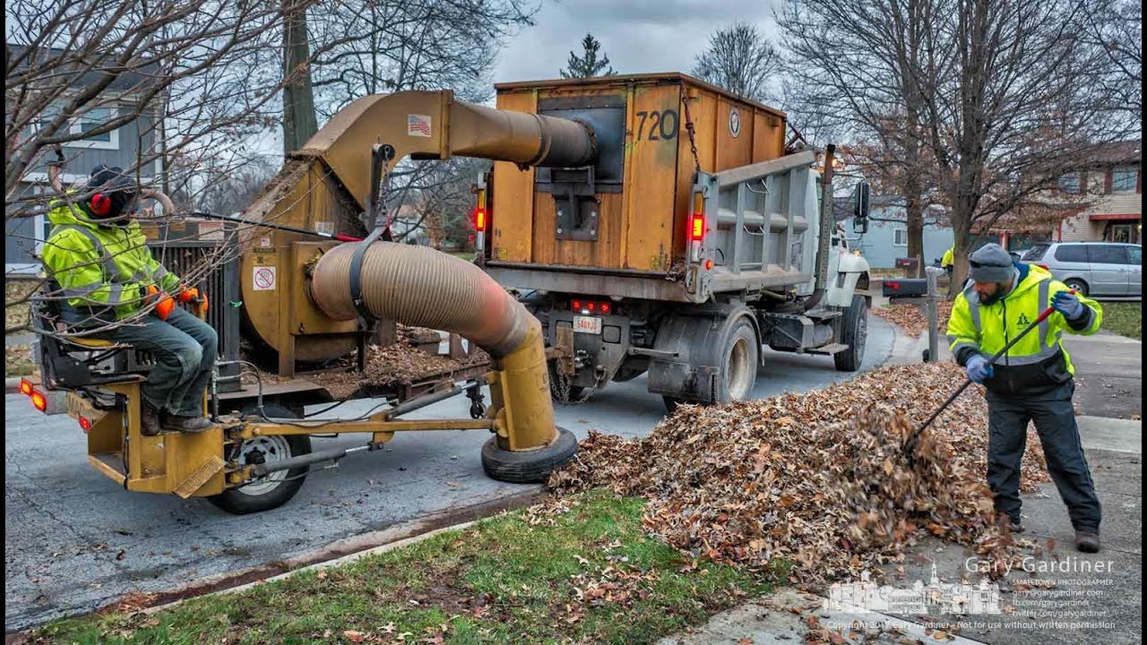 Westerville service department workers vacuum leaves.