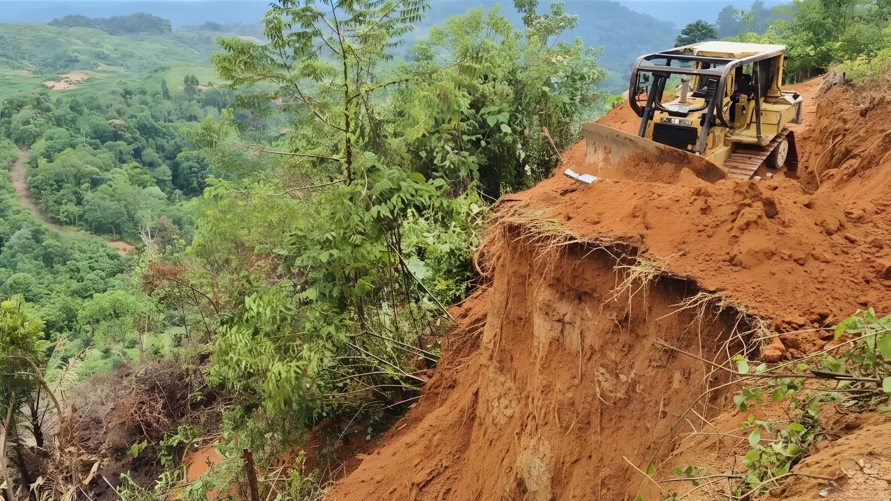 CAT D6R XL Dozer Builds New Road Next to Cliff Face Construction