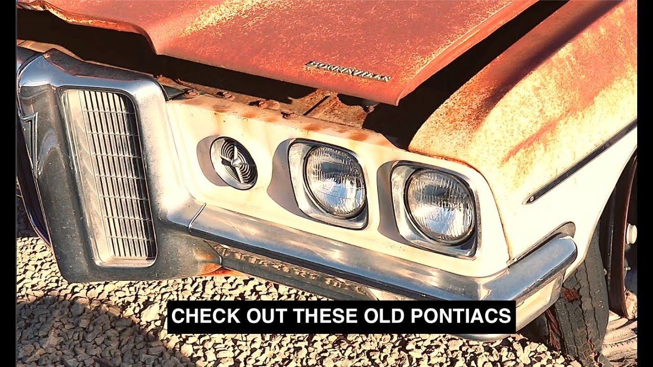 Old Pontiac Sitting Along Even More Old Pontiac Cars