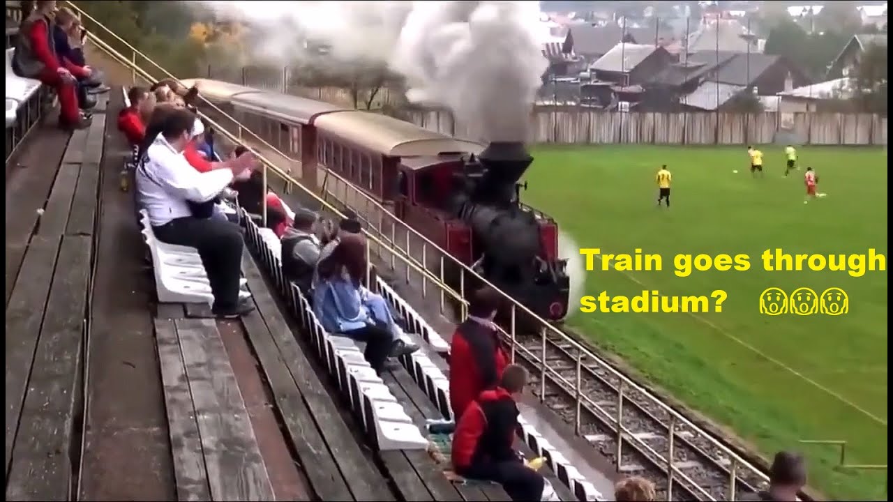 Train passes through stadium while football match goes on!