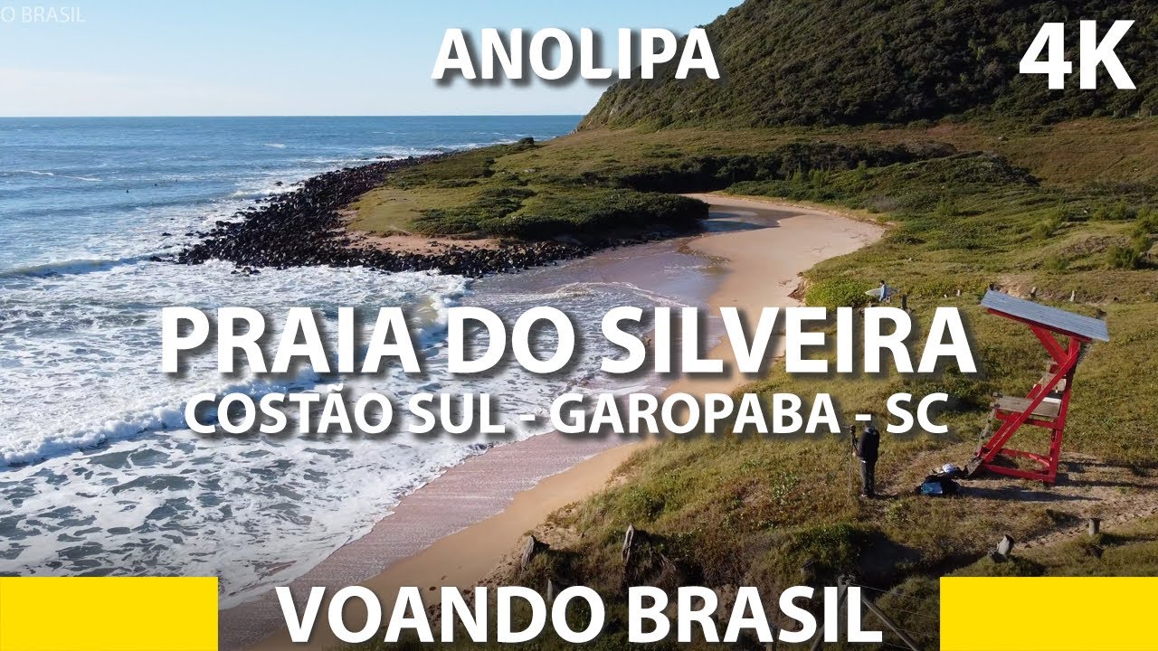 Praia do Silveira vista de cima. Costão direito com ondas - Garopaba, SC. Brasil 4K