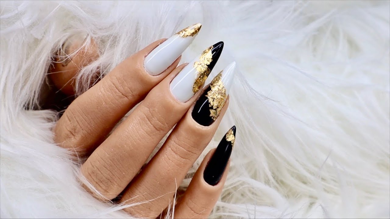 Classic: black and white nails with gold leaf