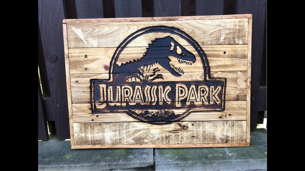 Handheld router carved Jurassic Park sign