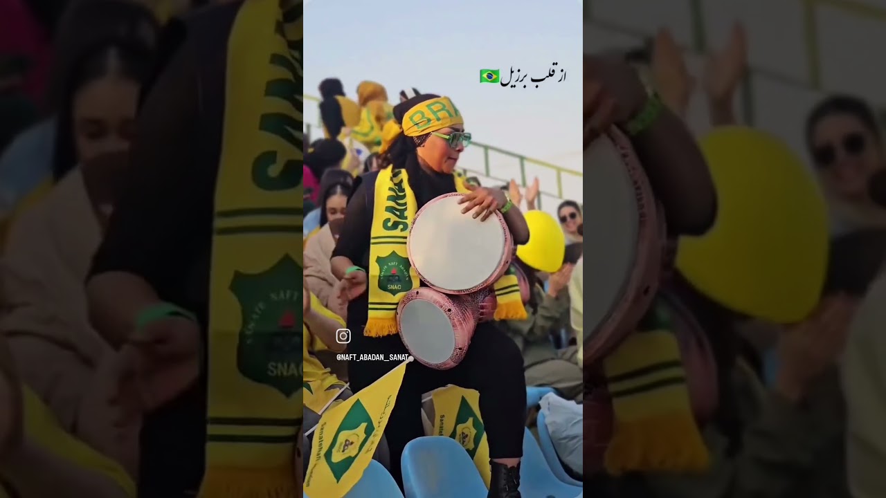 Iranian girl playing percussion in football stadium