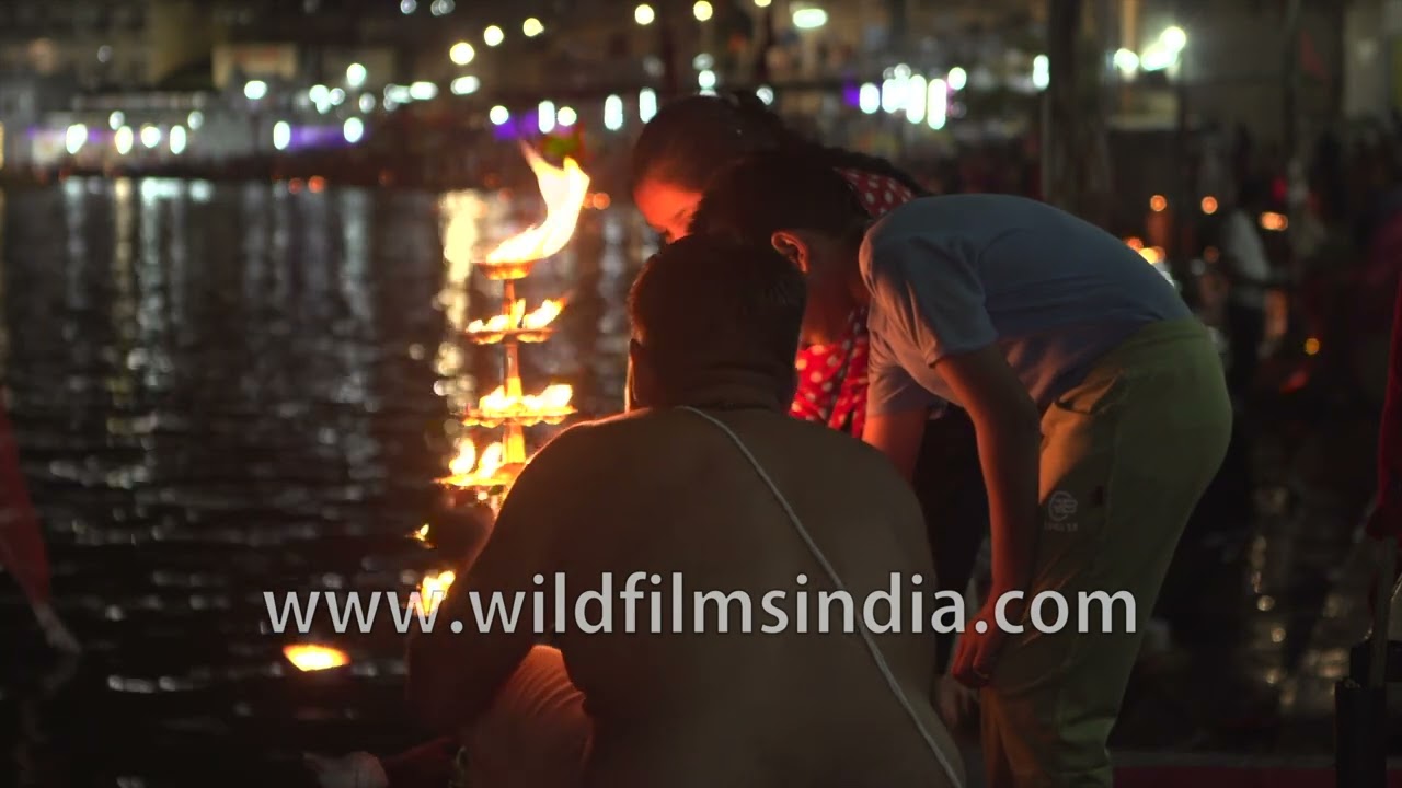 Pandit arranging lamps for evening aarti at Pushkar Lake