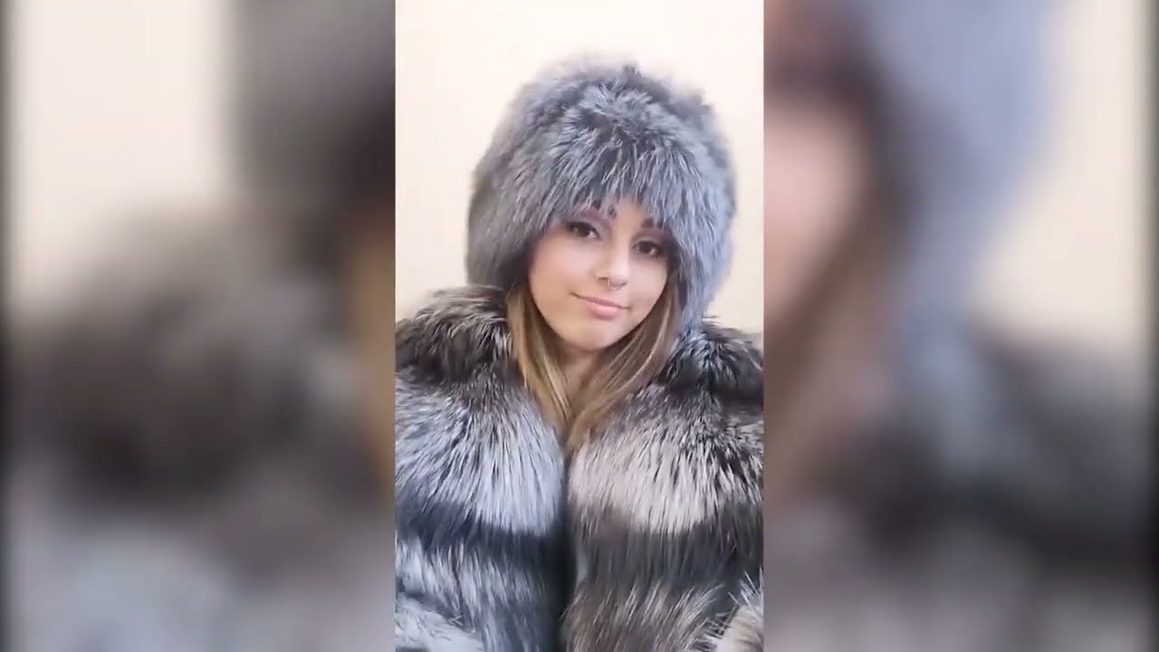Pretty girl in silver fox fur coat and hat