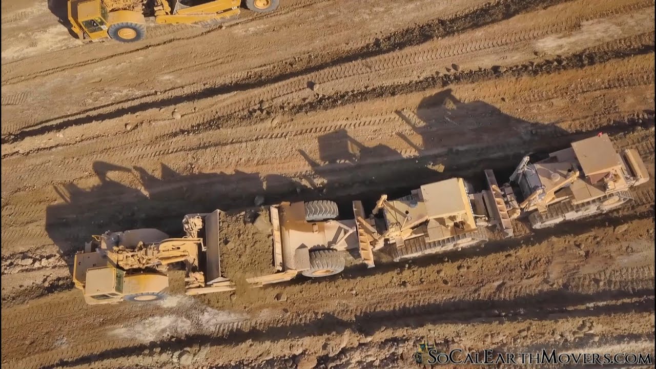 Double pushing CAT 651E and 651B scrapers with D10N dozers